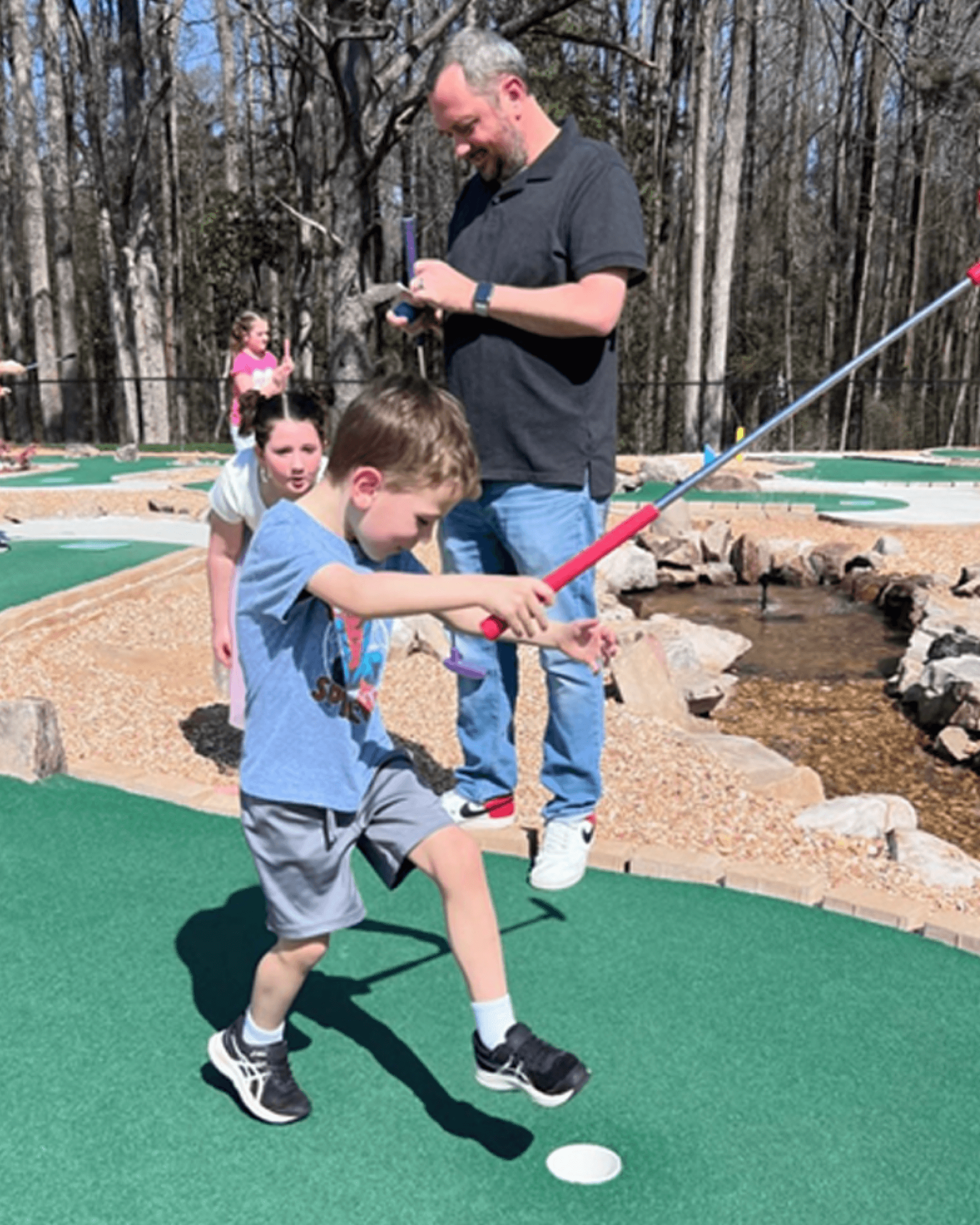 Family playing mini golf at Swing ATL